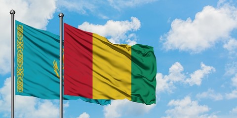 Kazakhstan and Guinea flag waving in the wind against white cloudy blue sky together. Diplomacy concept, international relations.