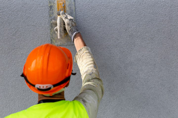 Worker hand applying decorative plaster