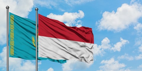 Kazakhstan and Indonesia flag waving in the wind against white cloudy blue sky together. Diplomacy concept, international relations.