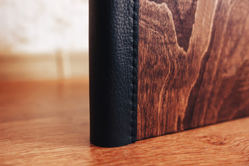 Leather binding of a wooden photo book. Leather binding photo book made of wood. Note book with...