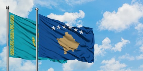 Kazakhstan and Kosovo flag waving in the wind against white cloudy blue sky together. Diplomacy concept, international relations.