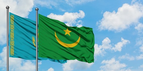 Kazakhstan and Mauritania flag waving in the wind against white cloudy blue sky together. Diplomacy concept, international relations.