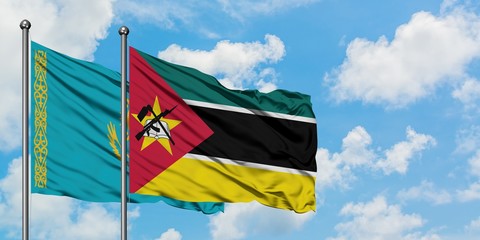 Kazakhstan and Mozambique flag waving in the wind against white cloudy blue sky together. Diplomacy concept, international relations.