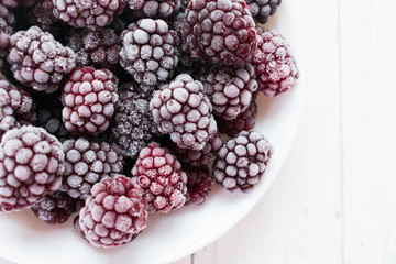  Frozen blackberries on a white background. Top view. Copy space.