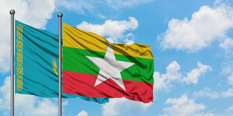 Kazakhstan and Myanmar flag waving in the wind against white cloudy blue sky together. Diplomacy concept, international relations.