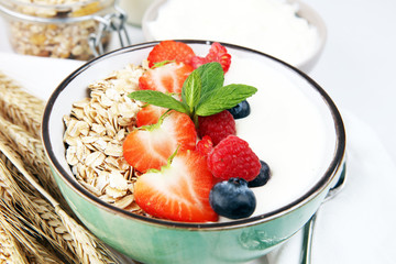 Tasty homemade granola served on table. Healthy breakfast with a bowl of oatmeal with banana, blueberries, strawberries and healthy food for Breakfast