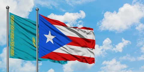 Kazakhstan and Puerto Rico flag waving in the wind against white cloudy blue sky together. Diplomacy concept, international relations.
