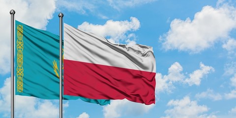 Kazakhstan and Poland flag waving in the wind against white cloudy blue sky together. Diplomacy concept, international relations.