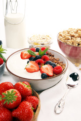 Tasty homemade granola served on table. Healthy breakfast with a bowl of oatmeal with banana, blueberries, strawberries and healthy food for Breakfast