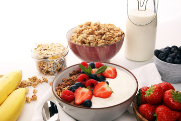Tasty homemade granola served on table. Healthy breakfast with a bowl of oatmeal with banana, blueberries, strawberries and healthy food for Breakfast