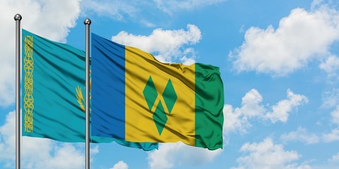 Kazakhstan and Saint Vincent And The Grenadines flag waving in the wind against white cloudy blue...