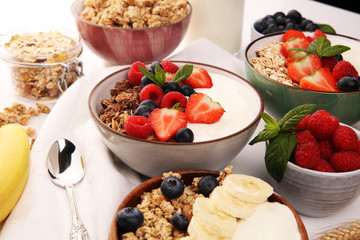 Tasty homemade granola served on table. Healthy breakfast with a bowl of oatmeal with banana, blueberries, strawberries and healthy food for Breakfast