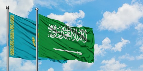 Kazakhstan and Saudi Arabia flag waving in the wind against white cloudy blue sky together. Diplomacy concept, international relations.