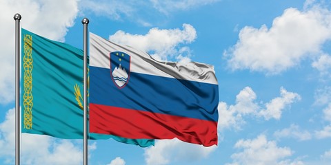 Kazakhstan and Slovenia flag waving in the wind against white cloudy blue sky together. Diplomacy concept, international relations.