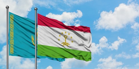 Kazakhstan and Tajikistan flag waving in the wind against white cloudy blue sky together. Diplomacy concept, international relations.