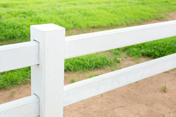 White concrete fence in farm field
