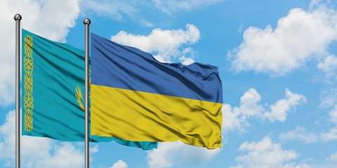 Kazakhstan and Ukraine flag waving in the wind against white cloudy blue sky together. Diplomacy concept, international relations.