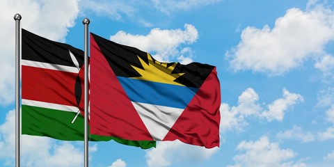 Kenya and Antigua and Barbuda flag waving in the wind against white cloudy blue sky together. Diplomacy concept, international relations.