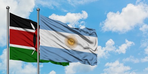 Kenya and Argentina flag waving in the wind against white cloudy blue sky together. Diplomacy concept, international relations.