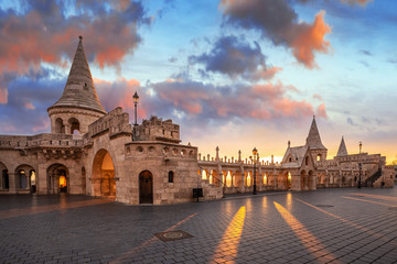 Fototapeta premium Budapest, Hungary - Beautiful autumn sunrise at Castle district and Fisherman's Bastion with warm sunlight and orange and blue sky and clouds