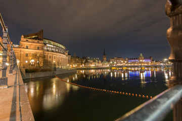 Side view of the Stockholm parliament house at night, long exposure, from the parliament access bridge, Sweden 2019