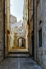 One of the narrow picturesque streets in Dubrovnik, old town, in summer, at noon