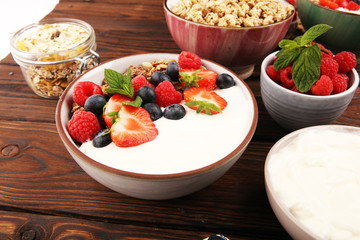 Tasty homemade granola served on table. Healthy breakfast with a bowl of oatmeal with banana, blueberries, strawberries and healthy food for Breakfast