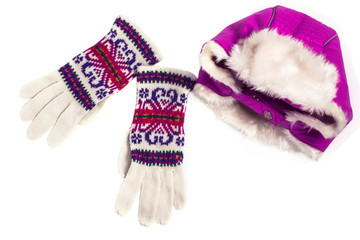 Fototapeta na wymiar Winter flatlay, warm purple hat with earflaps and colorful woolen knitted gloves on a white background. Top view, mockup for brand name, copy space. Shopping concept. Autumn and winter clothes.