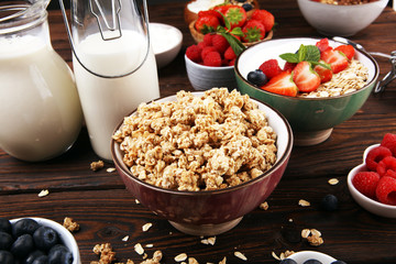 Tasty homemade granola served on table. Healthy breakfast with a bowl of oatmeal with banana, blueberries, strawberries and healthy food for Breakfast
