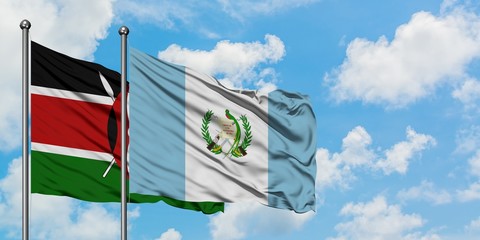 Kenya and Guatemala flag waving in the wind against white cloudy blue sky together. Diplomacy concept, international relations.