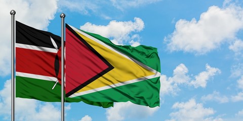 Kenya and Guyana flag waving in the wind against white cloudy blue sky together. Diplomacy concept, international relations.