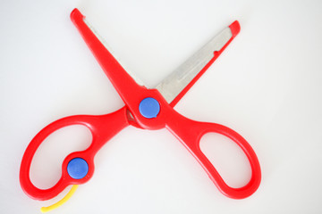 Red handle scissors placed on a white background - Image