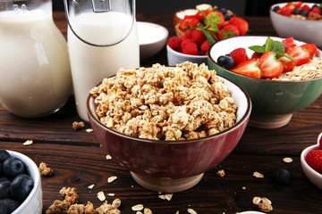 Tasty homemade granola served on table. Healthy breakfast with a bowl of oatmeal with banana, blueberries, strawberries and healthy food for Breakfast