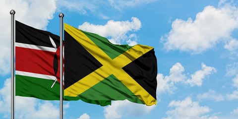 Kenya and Jamaica flag waving in the wind against white cloudy blue sky together. Diplomacy concept, international relations.
