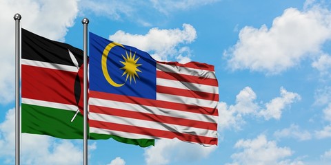 Kenya and Malaysia flag waving in the wind against white cloudy blue sky together. Diplomacy concept, international relations.