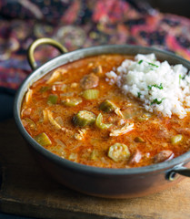 Close up view of chicken gumbo with a scoop of rice. 
