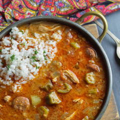 Overhead shot of chicken and sausage gumbo with a scoop of rice.  - obrazy, fototapety, plakaty