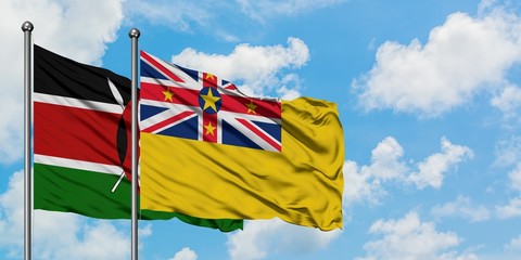 Kenya and Niue flag waving in the wind against white cloudy blue sky together. Diplomacy concept, international relations.