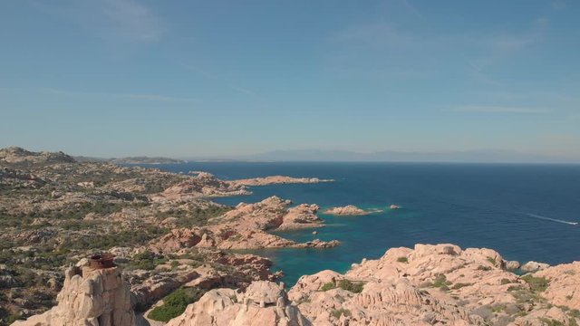 aerial drone 4k view of historical military camouflage fortress, scenic sea and amazing rocky coastline - batteria di candeo caprera sardinia italy