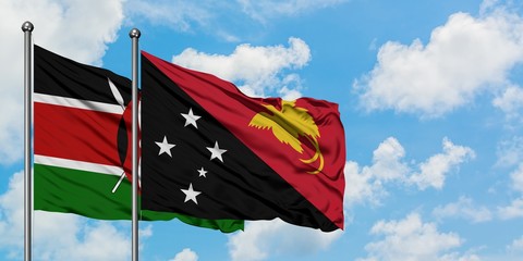 Kenya and Papua New Guinea flag waving in the wind against white cloudy blue sky together. Diplomacy concept, international relations.