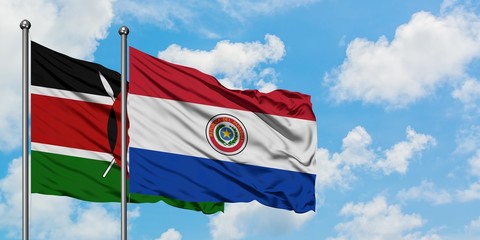 Kenya and Paraguay flag waving in the wind against white cloudy blue sky together. Diplomacy concept, international relations.