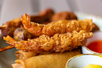 Dutch snacks for beer or wine, tempura shrimps, skewered chicken, bitterballs and hot dip sauces