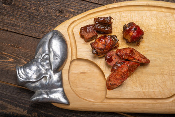 Sliced bbq on pig styled cutting board half view