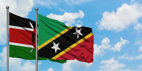 Kenya and Saint Kitts And Nevis flag waving in the wind against white cloudy blue sky together. Diplomacy concept, international relations.