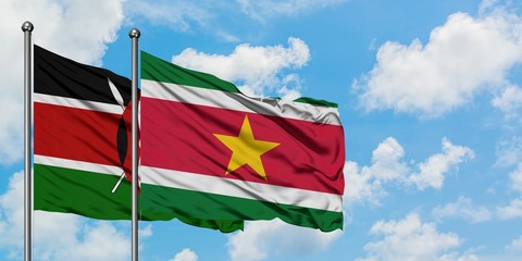 Kenya and Suriname flag waving in the wind against white cloudy blue sky together. Diplomacy concept, international relations.