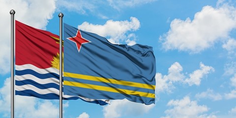 Kiribati and Aruba flag waving in the wind against white cloudy blue sky together. Diplomacy concept, international relations.