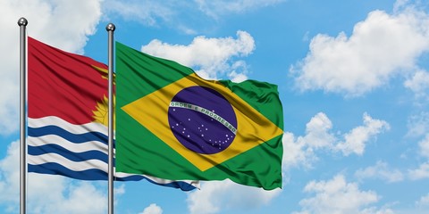 Kiribati and Brazil flag waving in the wind against white cloudy blue sky together. Diplomacy concept, international relations.
