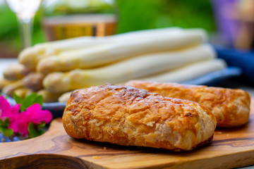 Pastry with bacon and white asparagus vegetables ready to eat served in spring garden