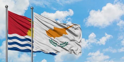 Kiribati and Cyprus flag waving in the wind against white cloudy blue sky together. Diplomacy concept, international relations.