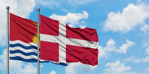 Kiribati and Denmark flag waving in the wind against white cloudy blue sky together. Diplomacy concept, international relations.